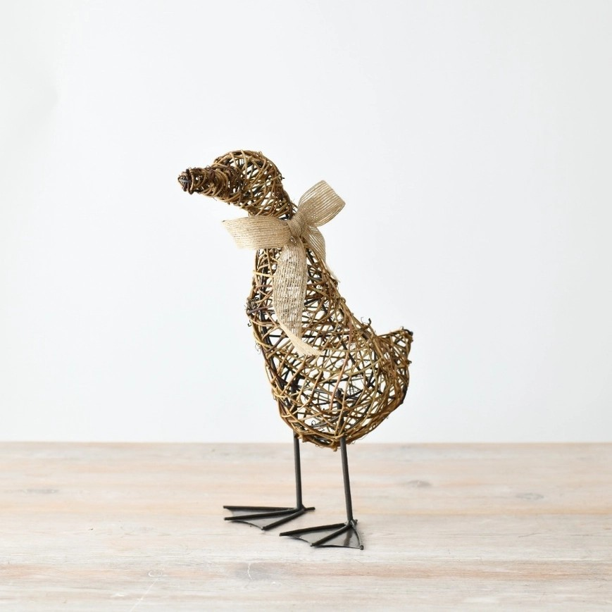 Rattan made suck ornament with metal legs, featuring a fabric hessian-style bow around its neck