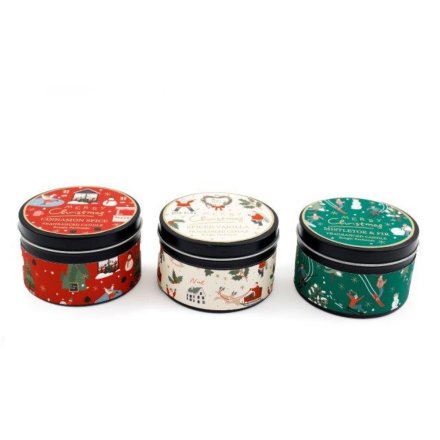 Three small cylindrical tins with festive designs on a white background