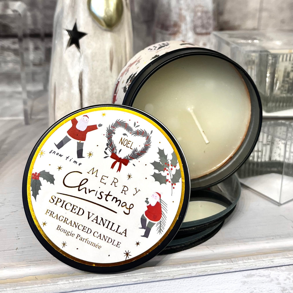 Spiced vanilla candle with a festive label on a wooden surface