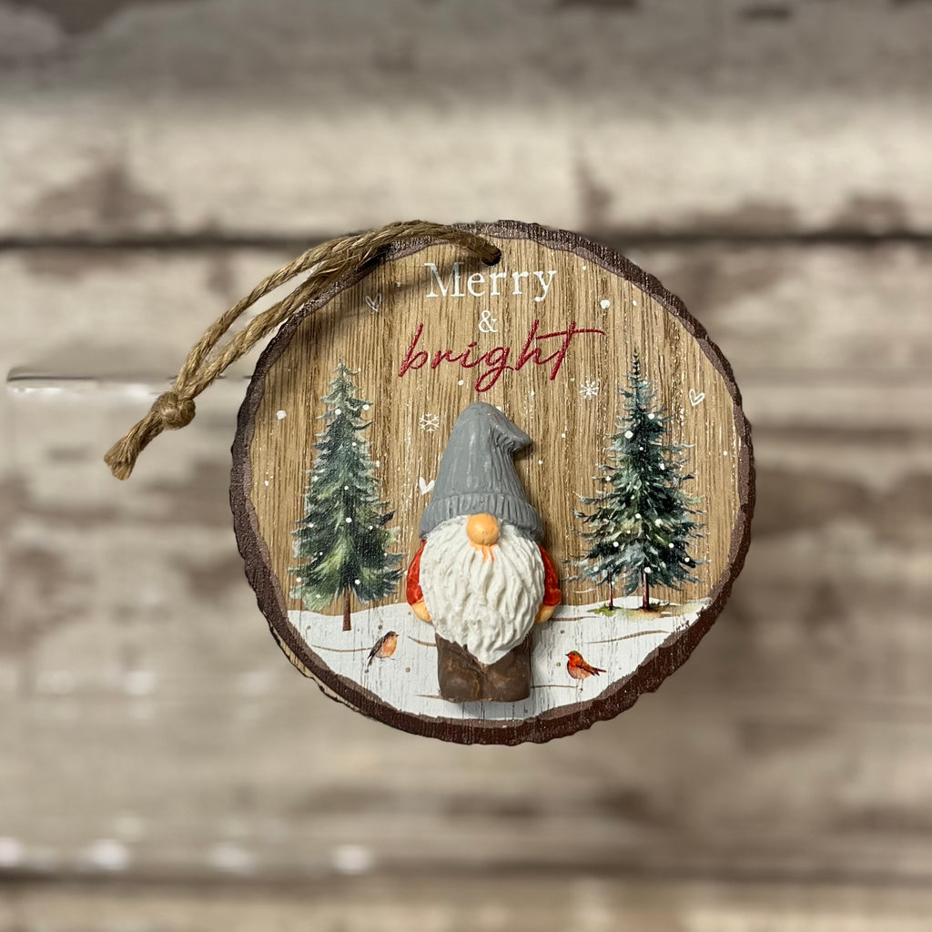 Wooden ornament with a gnome and trees, featuring 'Merry & Bright' text on a wooden background.