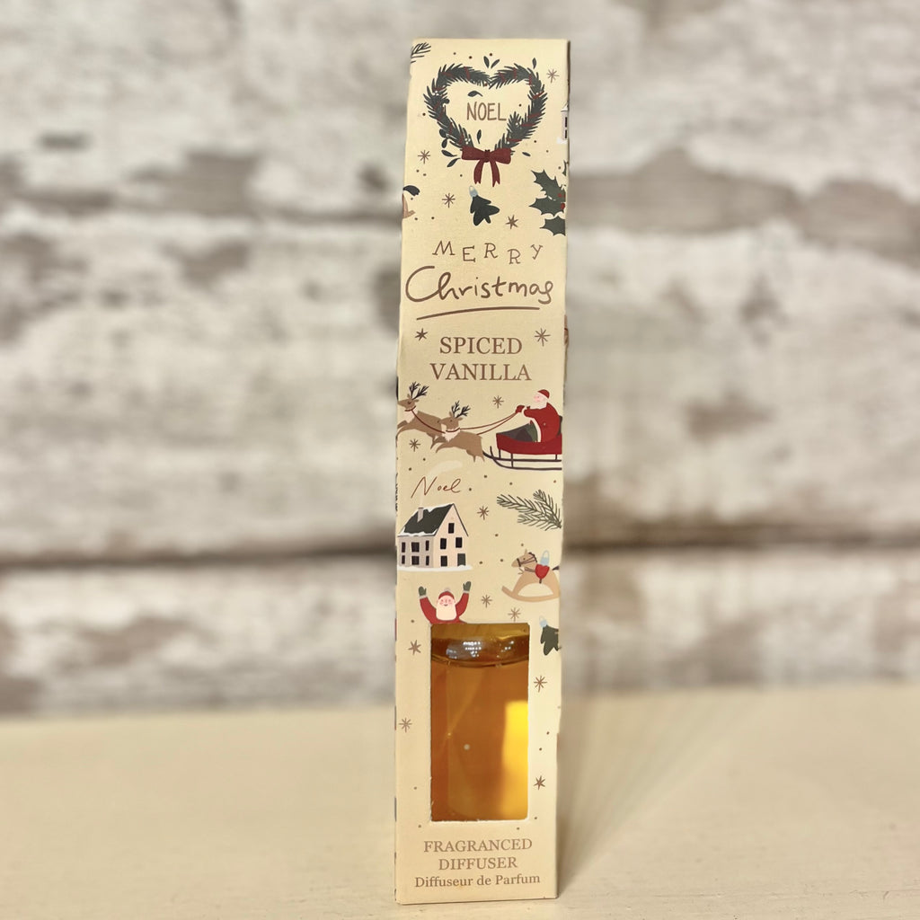 Christmas-themed spiced vanilla diffuser packaging with decorative elements on a neutral background