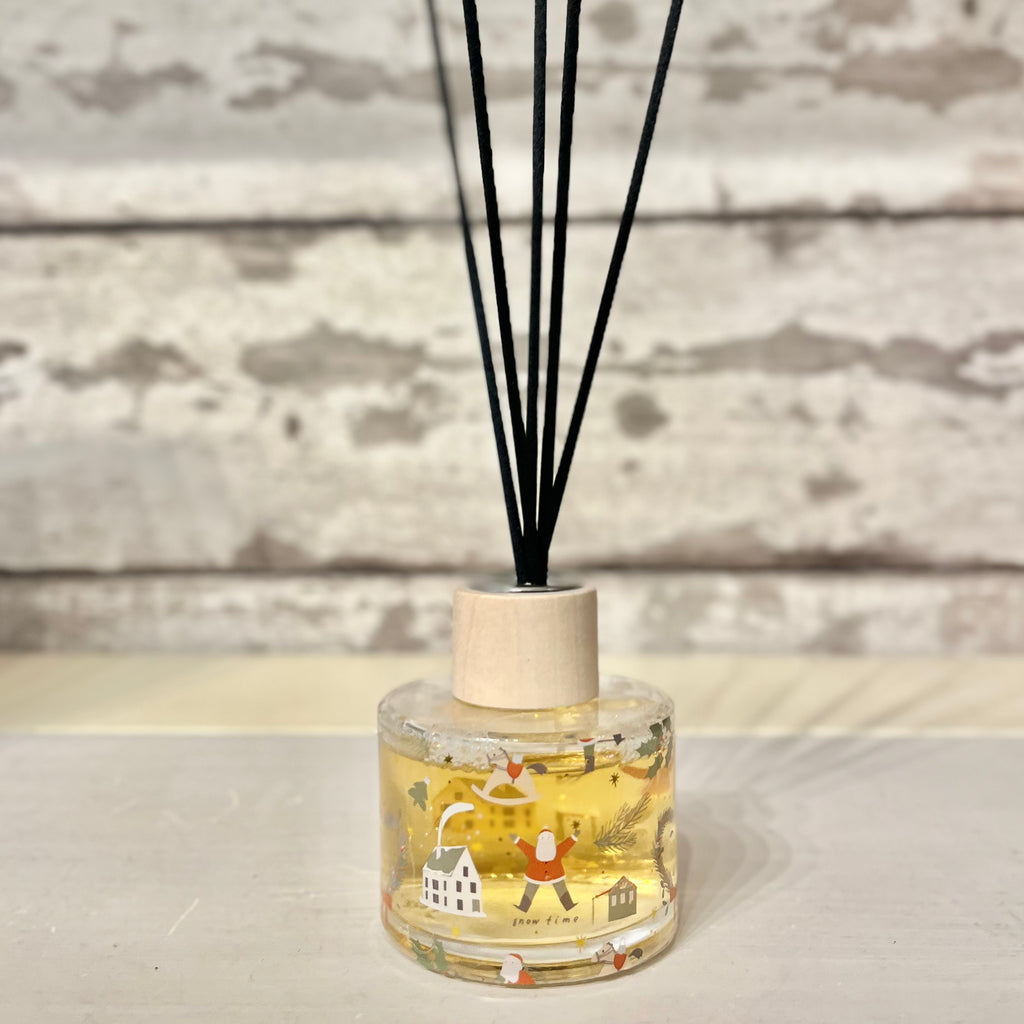 Diffuser with black sticks on a wooden surface