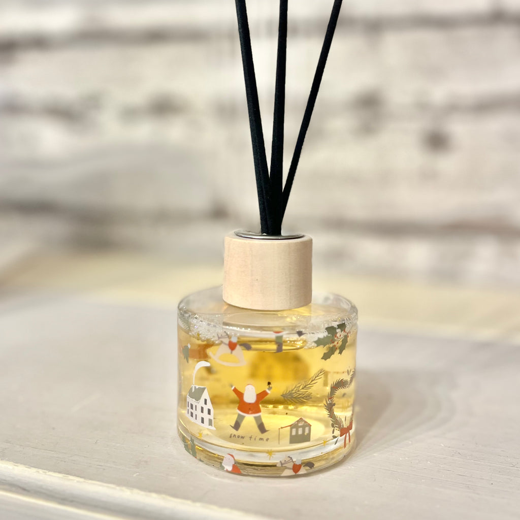 Clear diffuser bottle with decorative design on a light surface