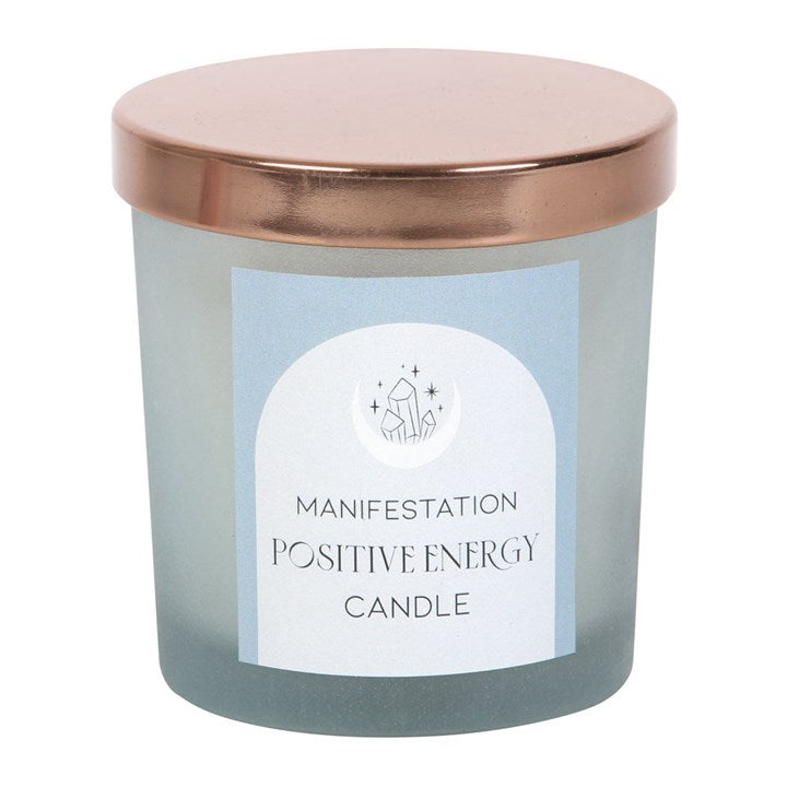 Blue frosted glass candle with copper-tone lid. Inside is a white candle with small clear quarts crystals embedded into the wax. 