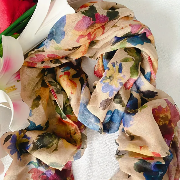 Dark cream floral scarf with dark blue, pink, yellow, and red flowers. Watercolour design.