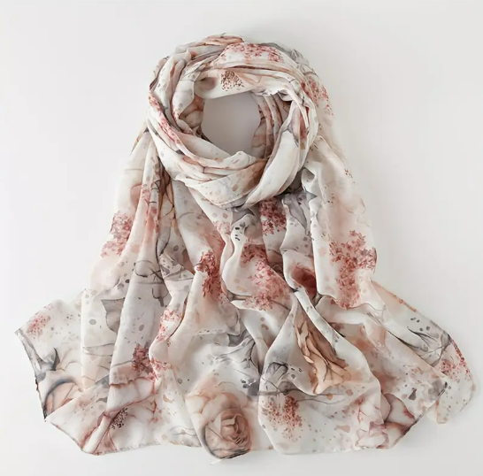 White scarf featuring intricate design with pink roses and other various pink flowers.