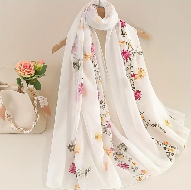 Lightweight white shawl embroidered with green vine featuring pink and orange flowers.
