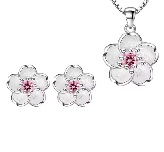 Silver chain necklace featuring a silver cherry blossom with pearlescent petals and pink crystal in the middle. Also comes with matching cherry blossom stud earrings. 
