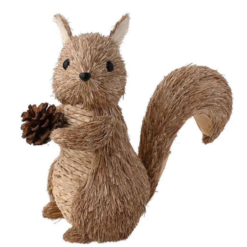 Rattan squirrel decoration standing up holding a pinecone 