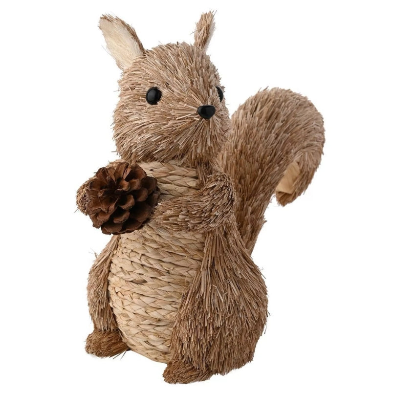 Rattan squirrel decoration standing up holding a pinecone 