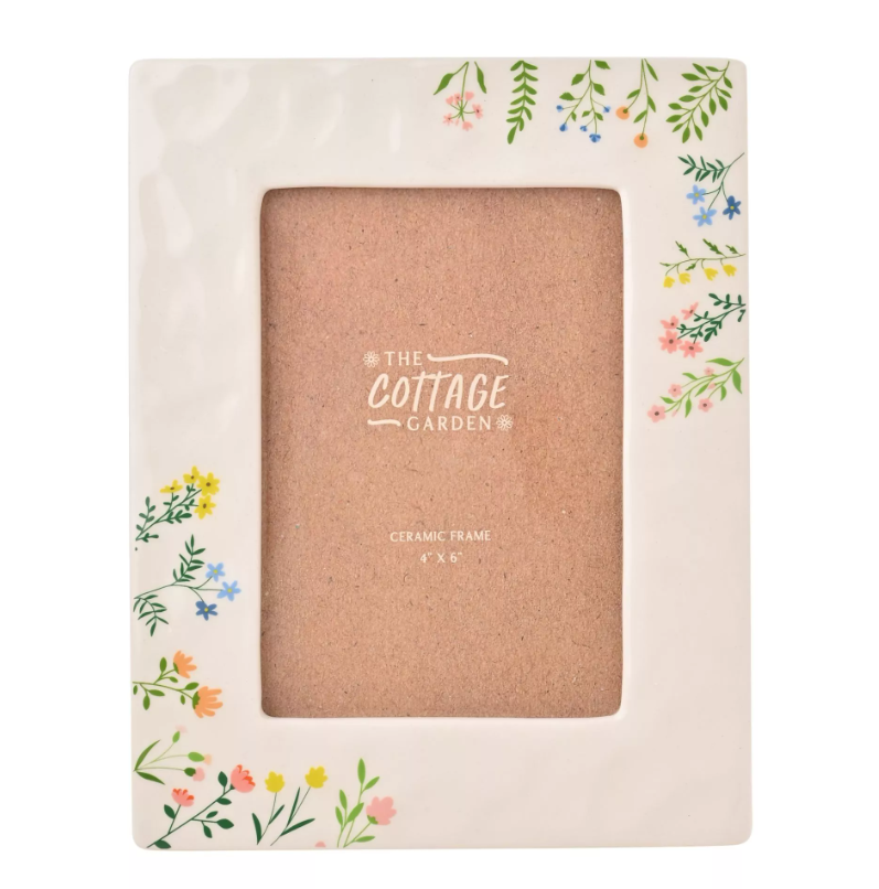 Floral decorated ceramic photo frame with 'The Cottage Garden' branding on a white background