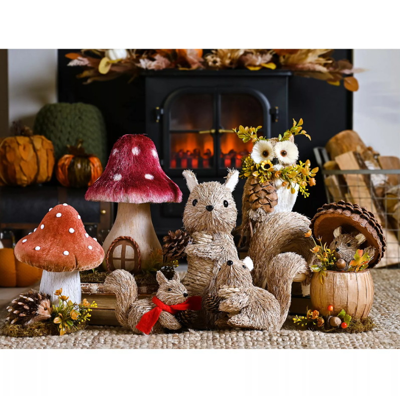Decorative items including plush squirrels, mushrooms, and an owl in front of a fireplace.