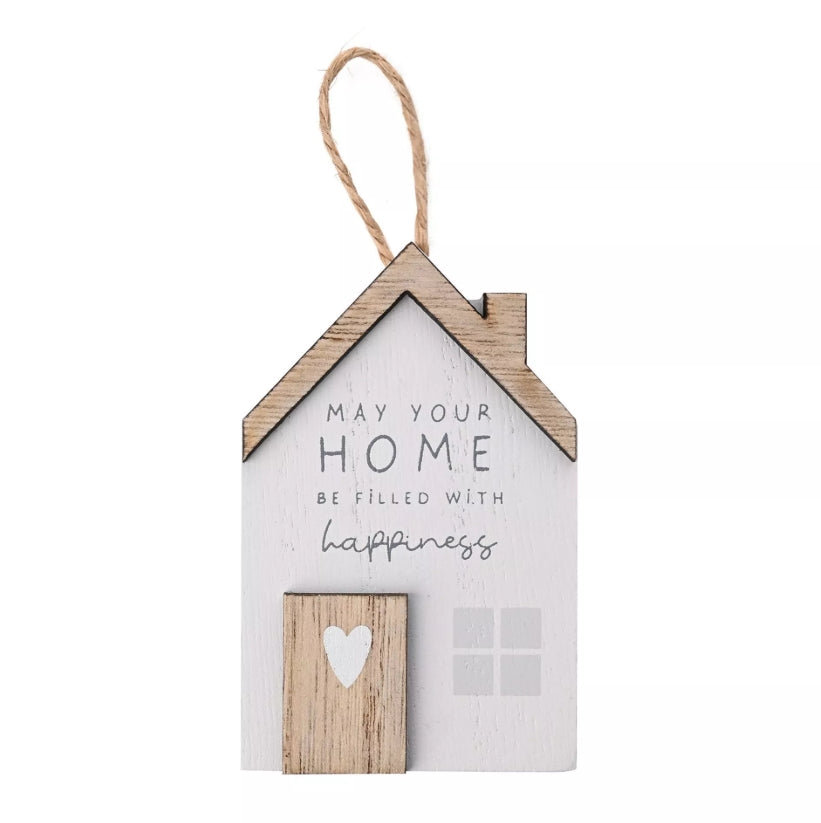 Decorative house-shaped sign with text and a heart on a white background