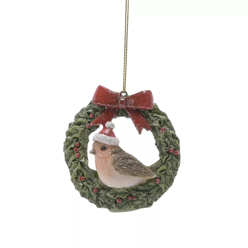 Christmas ornament with a bird in a wreath and red bow on a white background