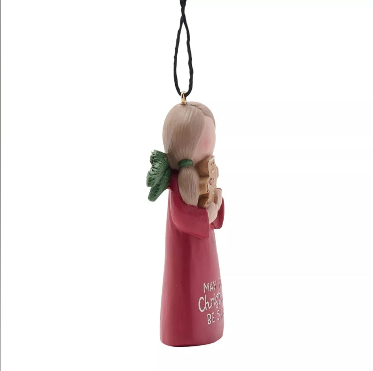 Decorative angel ornament with a pink dress and green leaf, on a white background