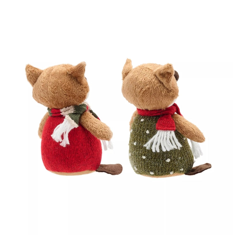 Two plush toy foxes wearing scarves on a white background