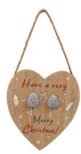 Heart-shaped wooden sign with two stone characters and Christmas message on a white background