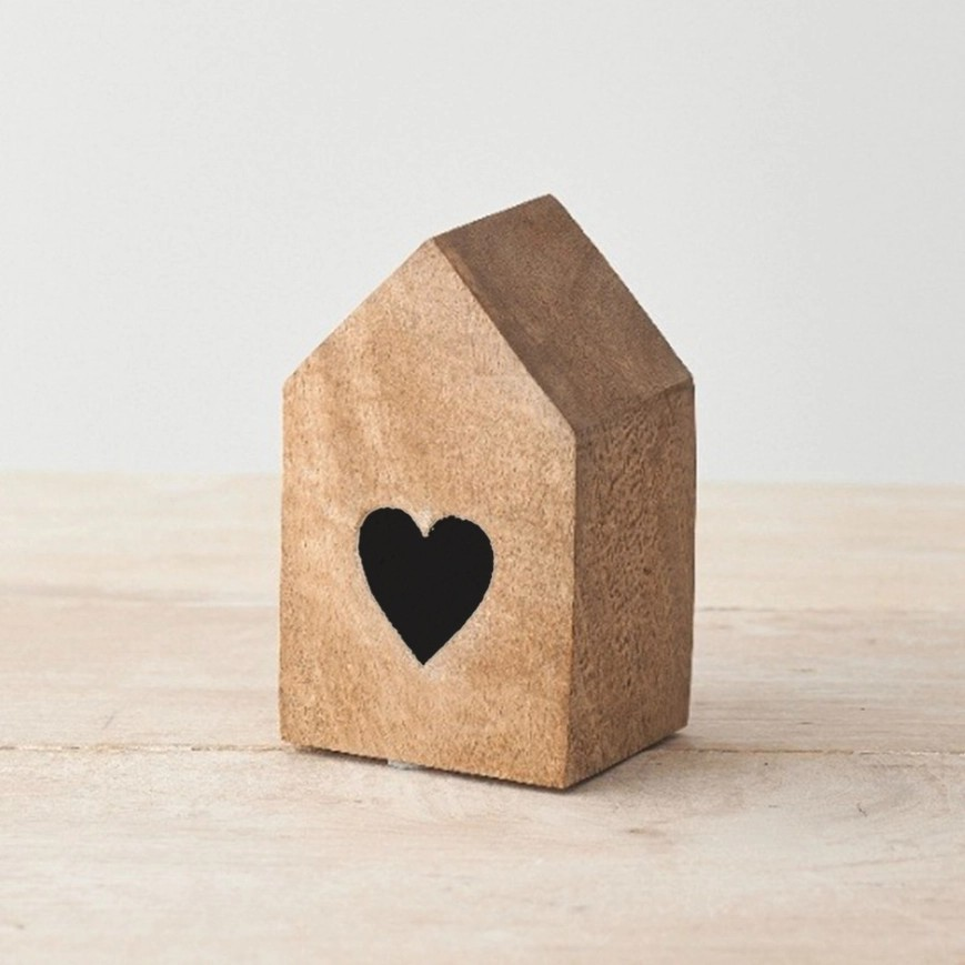 Simplistic house shaped wooden block with a burnt/engraved heart in the center. 