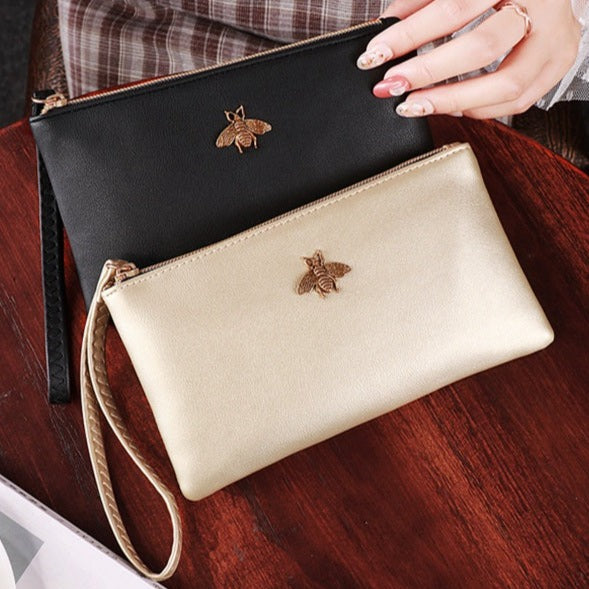 metallic clutch bag bee pendant